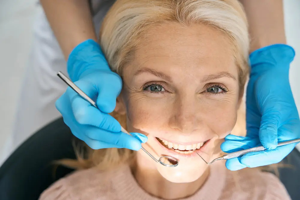 older woman in patient chair getting dental bridges